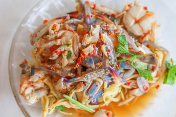 Papaya salad and fresh blue crab in dish , Thai food