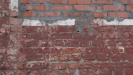 The texture of the brick wall and plaster.