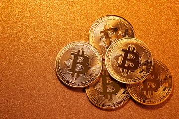 Bitcoin over golden glitter background. Business concept.