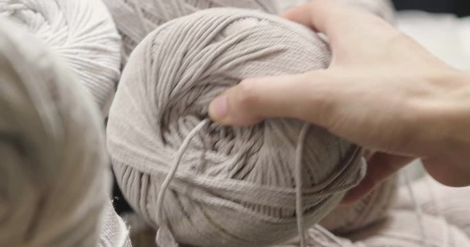 Close up of a hand touching raw, warm and soft wool. Concept of: tenderness, softness, warm, clothes.