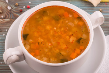 Home-made rassolnik with cucumbers, potato, carrots and greens