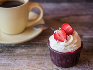 capcake with strawberries and a cup of coffee