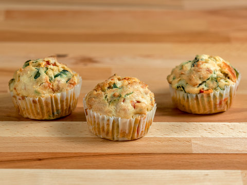 Freshly baked savoury muffins with cheddar, spinach and bell pepper
