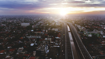 Fototapeta premium Beautiful aerial sunset view of Becakayu Toll way in East Jakarta