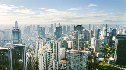 Panoramic cityscape of Indonesia capital city Jakarta downtown at sunny day. - obrazy, fototapety, plakaty