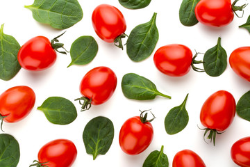 Spinach and tomato pattern background on white. Top view
