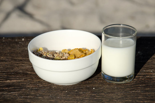 Conflex crispy and fresh milk on old wooden, healthy breakfast.