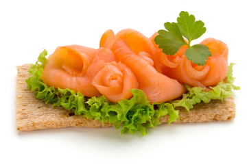 Bread with fresh salmon fillet isolated on white background, top view.