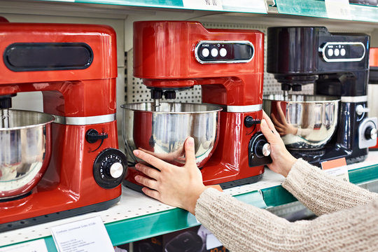 Woman selects electric food processor