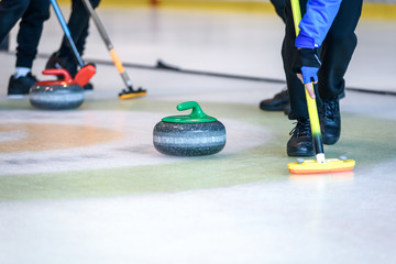 Team members play in curling at the championship. - obrazy, fototapety, plakaty