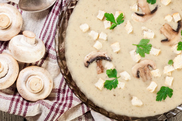 Mushroom cream soup with croutons and spices