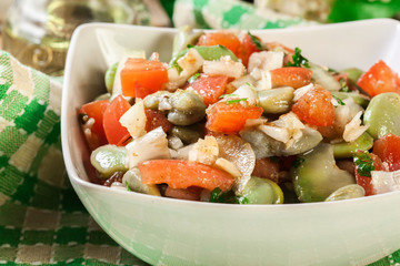 Broad bean salad with tomatoes, onion and olive