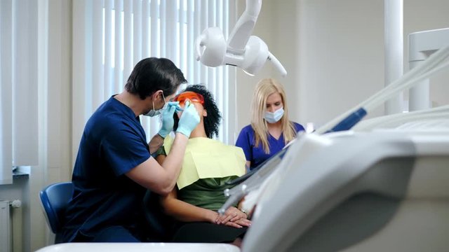 Dentist and his assitant working in private practice.