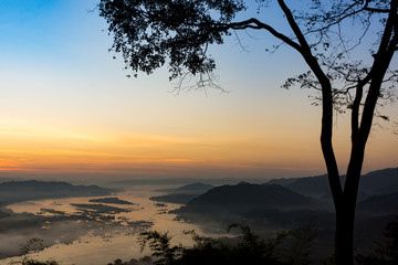 scenery of Mekong river with many fog in morning sunrise, View from viewpoint of Phu huai esun at Nongkhai, Thailand