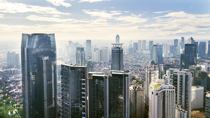 Jakarta cityscape with modern office buildings and apartments under blue sky