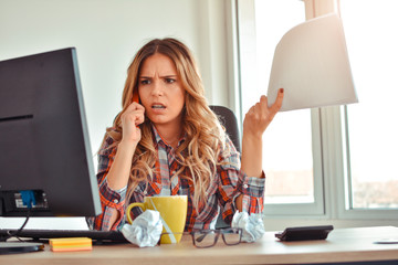 angry businesswoman looking at negative statistic