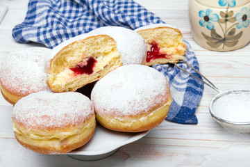 Traditional Polish donuts on wooden background.  Tasty doughnuts with jam.