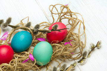 Easter background with colorful egg and catkins, copy space