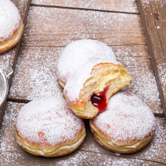 Traditional Polish donuts on wooden background.  Tasty doughnuts with jam.