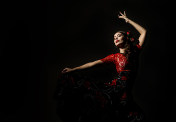 flamenco dancer on a dark background. free space for your text - obrazy, fototapety, plakaty