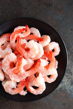 Fresh prawns. Raw shrimps, prawns. Seafood. Top view. Dark background
