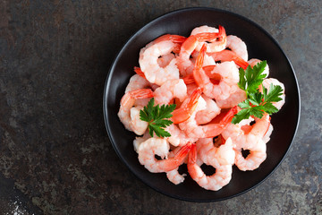 Prawns on plate. Shrimps, prawns. Seafood. Top view. Dark background