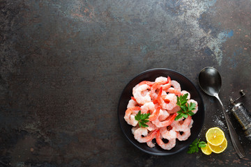 Prawns on plate. Shrimps, prawns. Seafood. Top view. Dark background