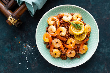 Prawns roasted on grill and boiled brown rice on plate. Grilled shrimps, prawns with rice. Seafood....