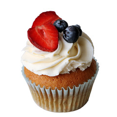 Cupcake with whipped cream, fresh strawberries, blueberries on white background. Fresh homemade cakes.