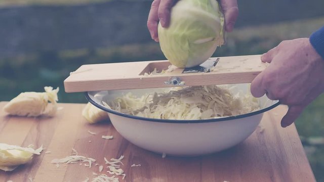 video shows how to slice cabbage for homemade sauerkraut - slow motion