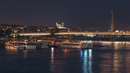 Fototapeta na wymiar Night view of Unkapani Ataturk subway bridge on the Golden Horn in Istanbul, Turkey.