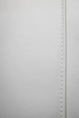 White leather texture with seams in close-up as a background