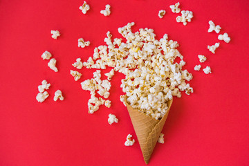 Naklejka na ściany i meble popcorn in a wafer for ice cream on a red background