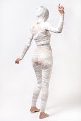 Slim young beautiful woman with bandages. Back view