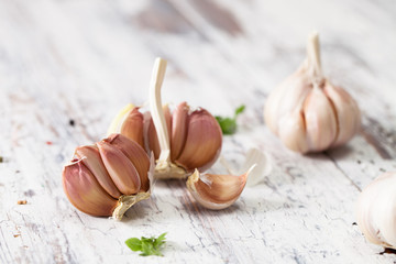 The broken head of garlic on old wooden table