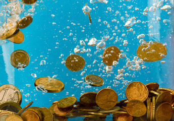 a pile of coins floating in the water