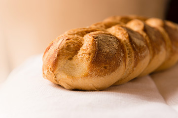 Homemade bread resting on a white cloth with natural light.