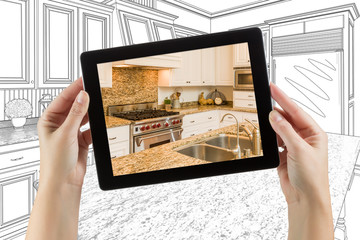 Female Hands Holding Computer Tablet with Kitchen on Screen & Drawing Behind.