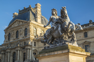 Fototapeta na wymiar Stone statue of Louvre Palace in Paris