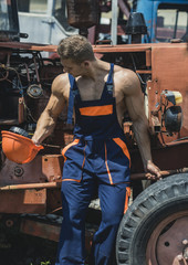 Tired worker concept. Muscular builder on sunny day.