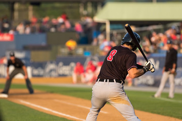 baseball player swinging at a pitch