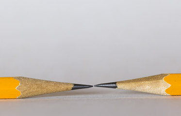 A group of pencils isolated on white. The pencils tips are nearly touching each other. This is a macro image.