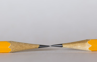 A group of pencils isolated on white. The pencils tips are nearly touching each other. This is a macro image.