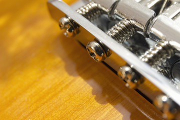 Fototapeta na wymiar Electric sunburst guitar bridge close-up macro