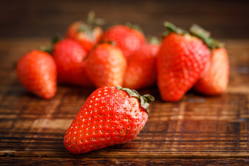 Ripe strawberries on wooden table on blurred background.Fresh delicious berries. Macro.