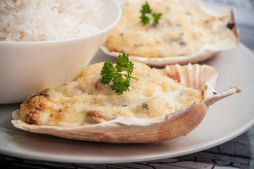 closeup of scallops shell and rice in a plate