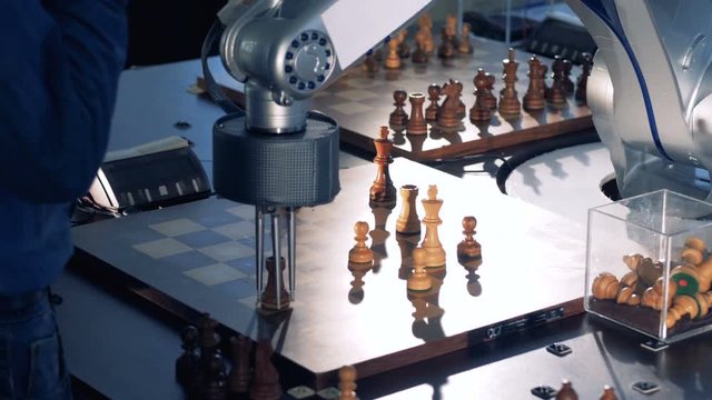 The process of game between chess player and robot.
