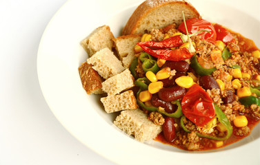 Chili con carne with Rye bread in white dish on white background