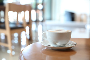 cappuccino or Latte art coffee made from milk on the wood table in coffee shop