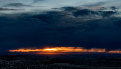 Storm clouds over Nampa Idaho with sun and rain streaks